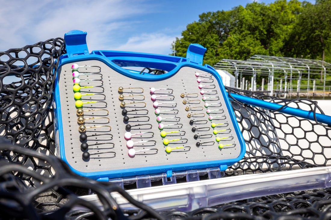 Fishing lure tray with various lures on a boat deck